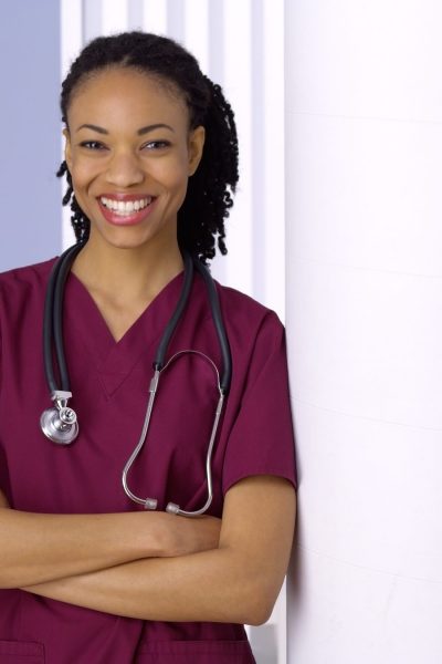 Confident black woman doctor smiling in office